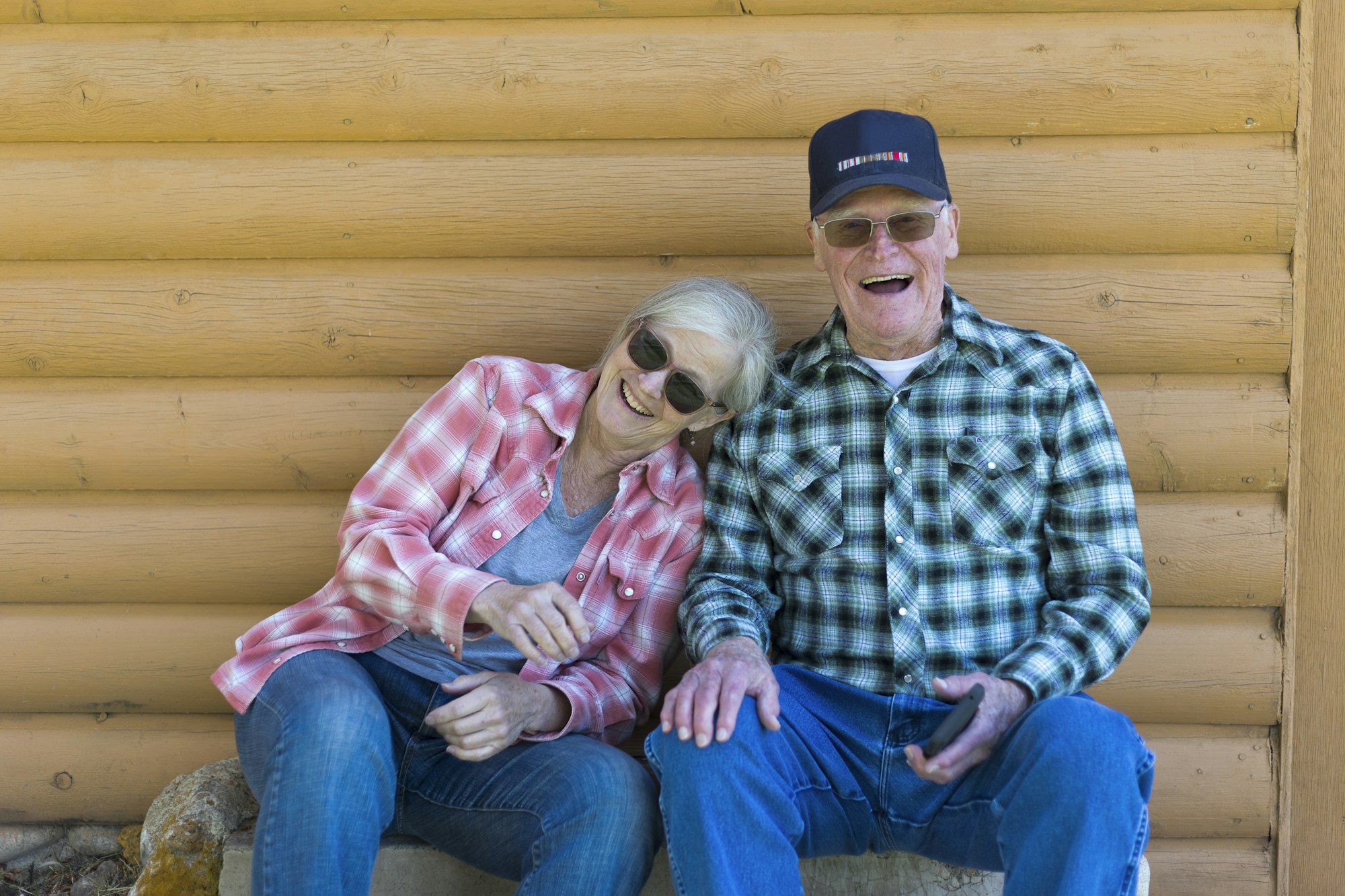 An older couple smiling and relaxing together outdoors